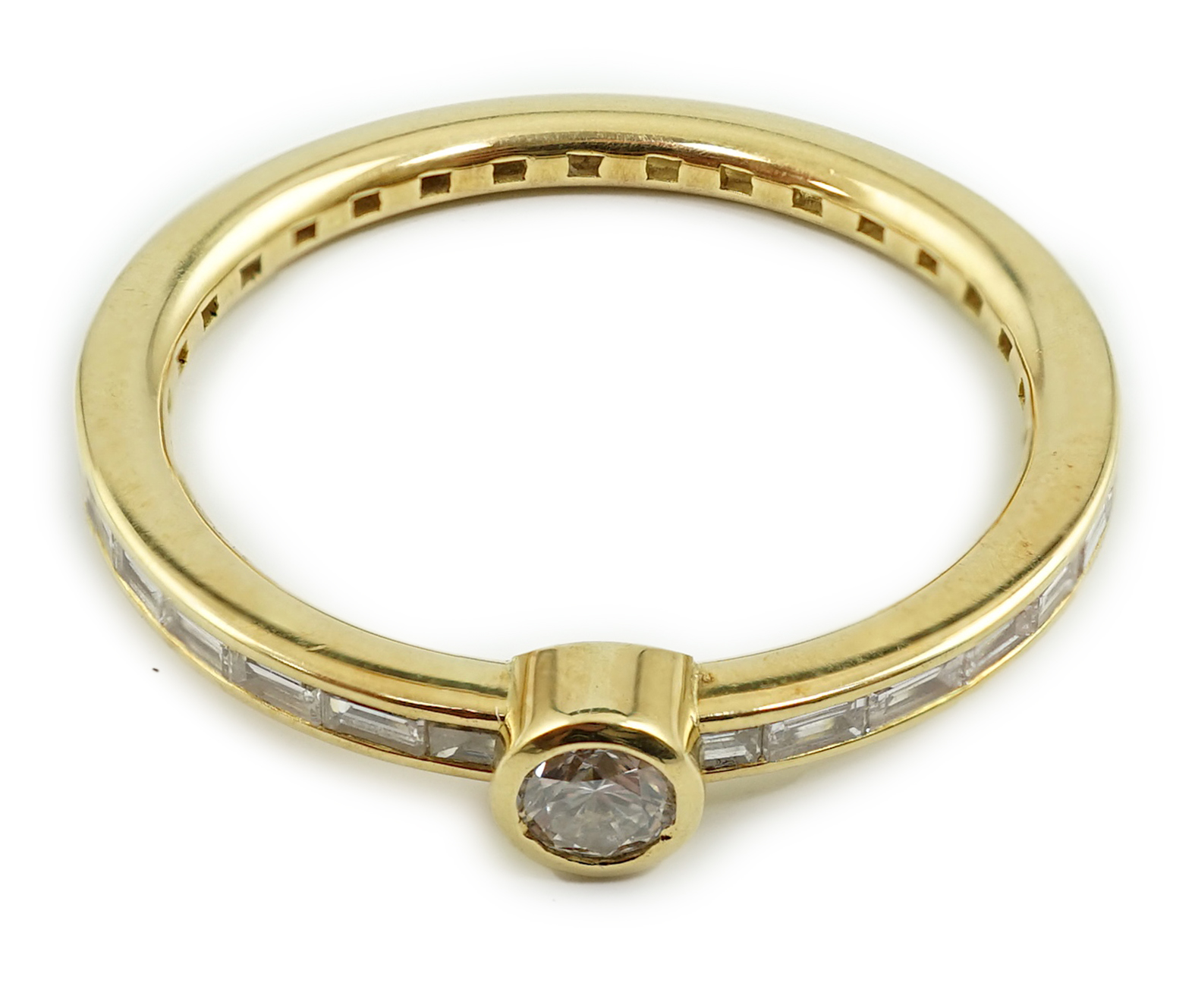 A modern 18ct gold, round and baguette cut diamond set ring